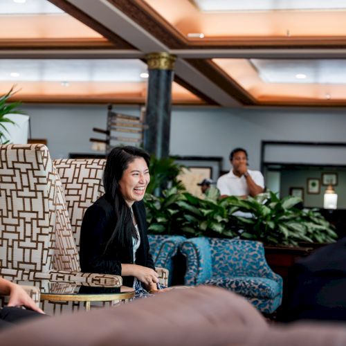 A classroom or lecture hall with students and a presenter at the front, engaged in a discussion or presentation.